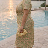 Vestido midi efeito modelador com nó central e caimento fluido